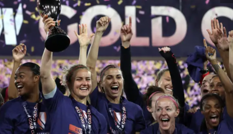 USWNT captain Lindsey Horan lifts the first-ever CONCACAF W Gold Cup trophy after securing victory over Brazil